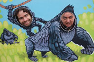 Simon and Eugene look through the gorilla cutouts at Bristol Zoo Gardens.